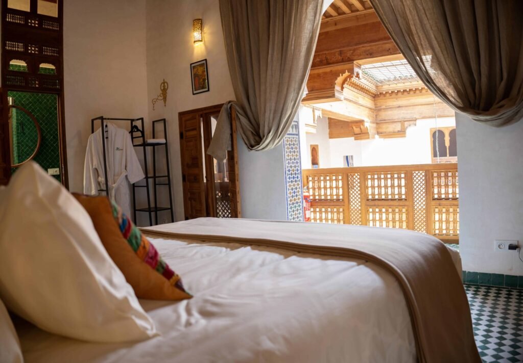 Luxury riad room in Fes with traditional Moroccan architecture and courtyard balcony