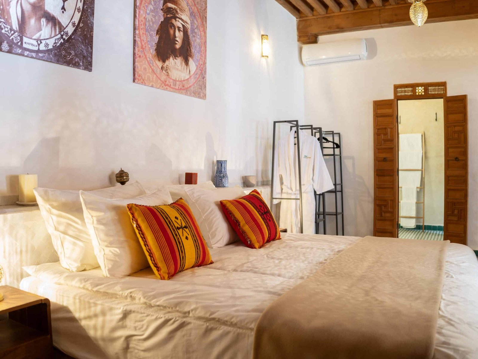 Elegant king-size bedroom in a traditional Moroccan riad featuring handcrafted décor, wooden ceiling, and authentic accommodation in Fes