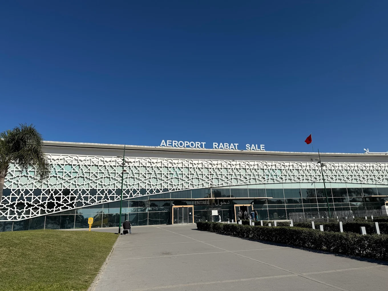 Exterior view of Rabat–Salé Airport terminal in Morocco with modern Moroccan-inspired architecture.