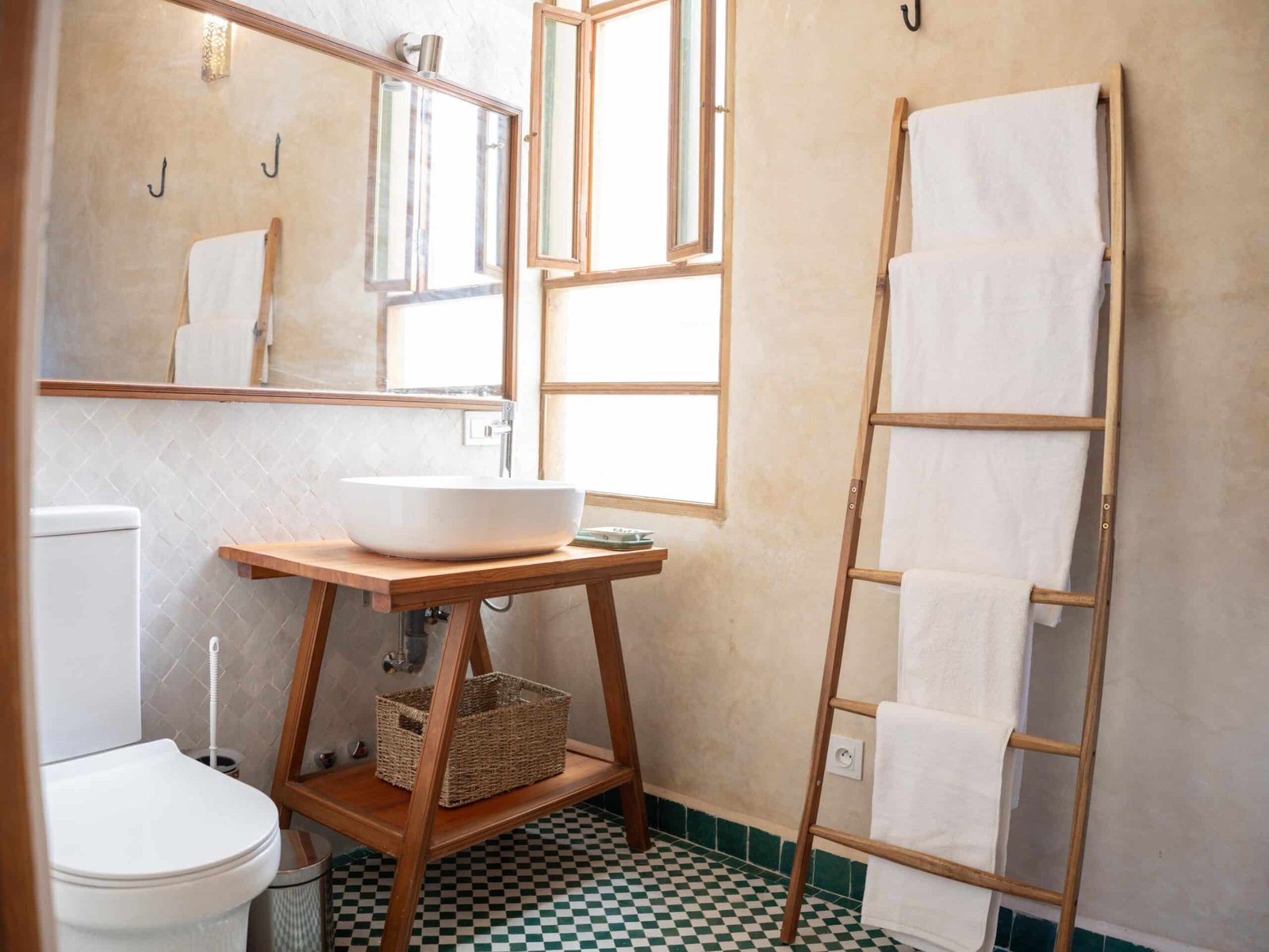 Modern ensuite bathroom at Riad Dar Flores in Fes featuring a handcrafted wooden vanity, vessel sink, natural light, and authentic Moroccan design.