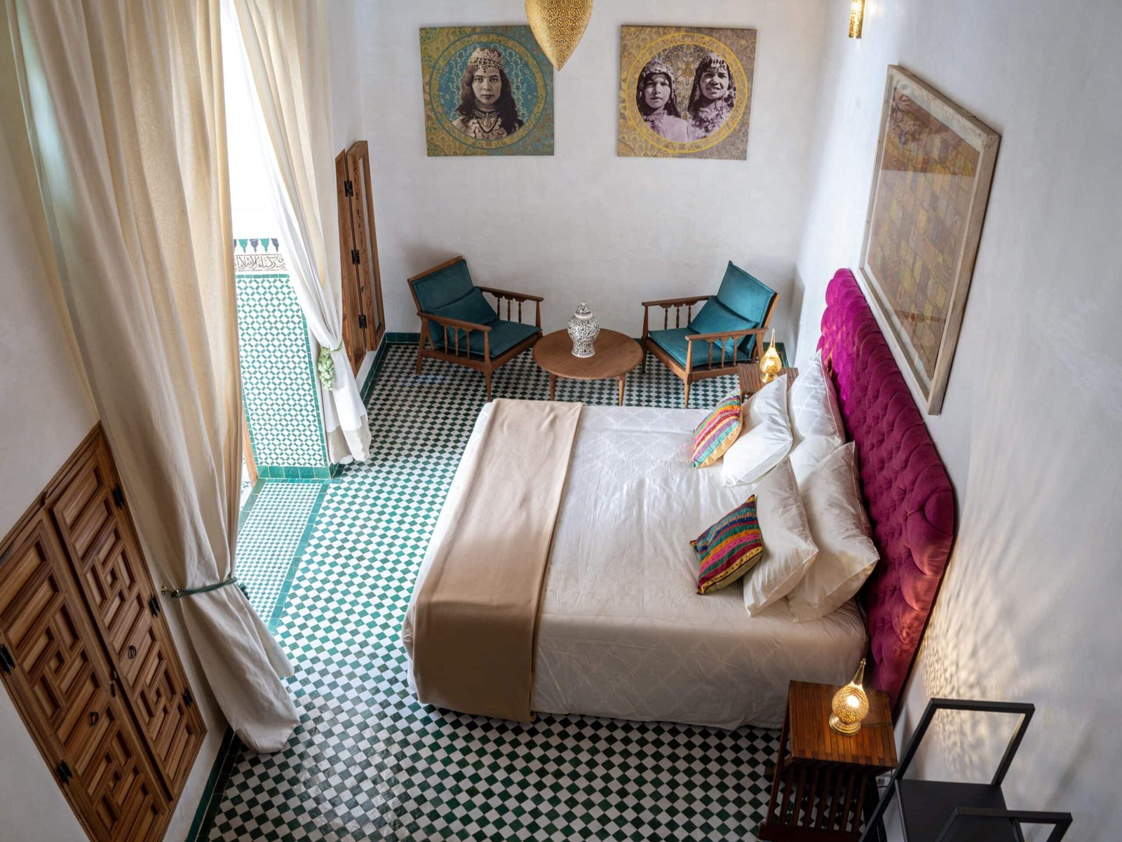 Vue en hauteur d'une chambre de riad à Fès avec lit king-size et espace détente.