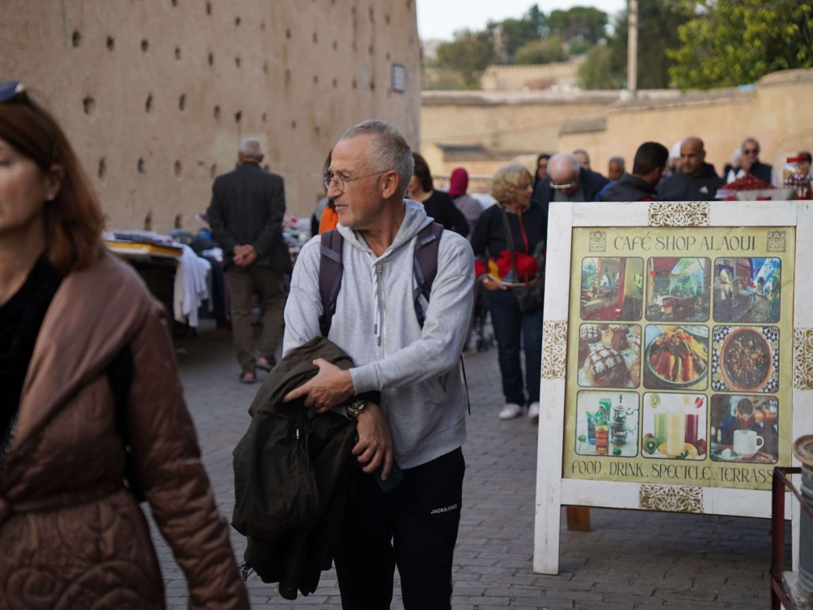 Visitor walking near Café Shop Alaoui during a guided tour in the Medina of Fez.