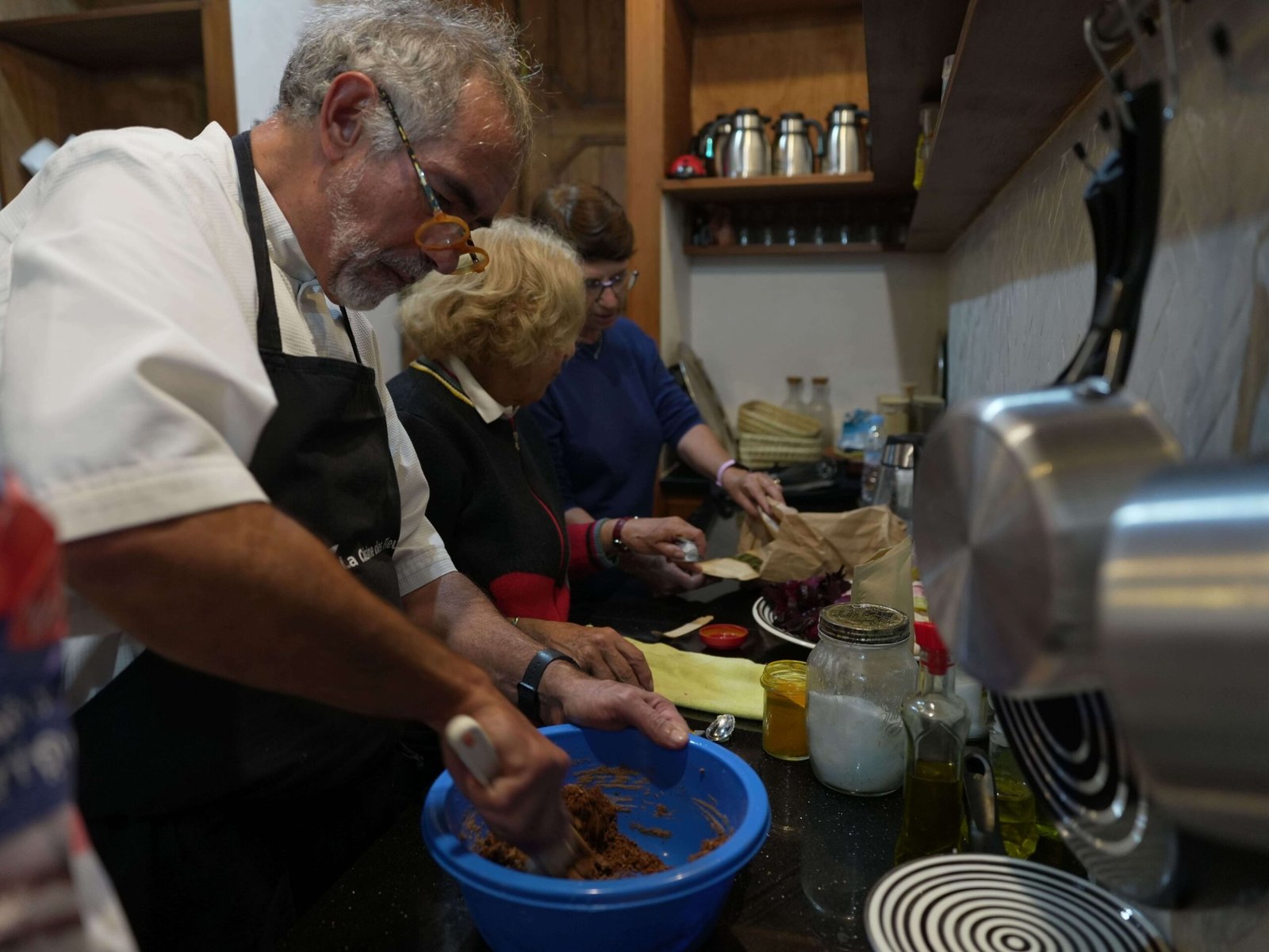 Participants preparing Moroccan dishes together in a kitchen