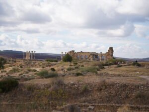 Ancient Roman basilica and stone arches at the archaeological site of Volubilis, Morocco.